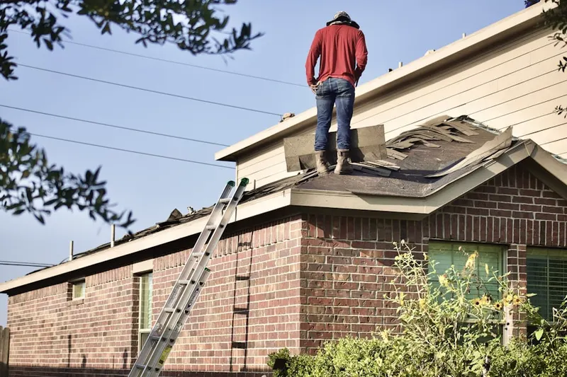 Professional roofer working on a residential roof in Ferry Farms